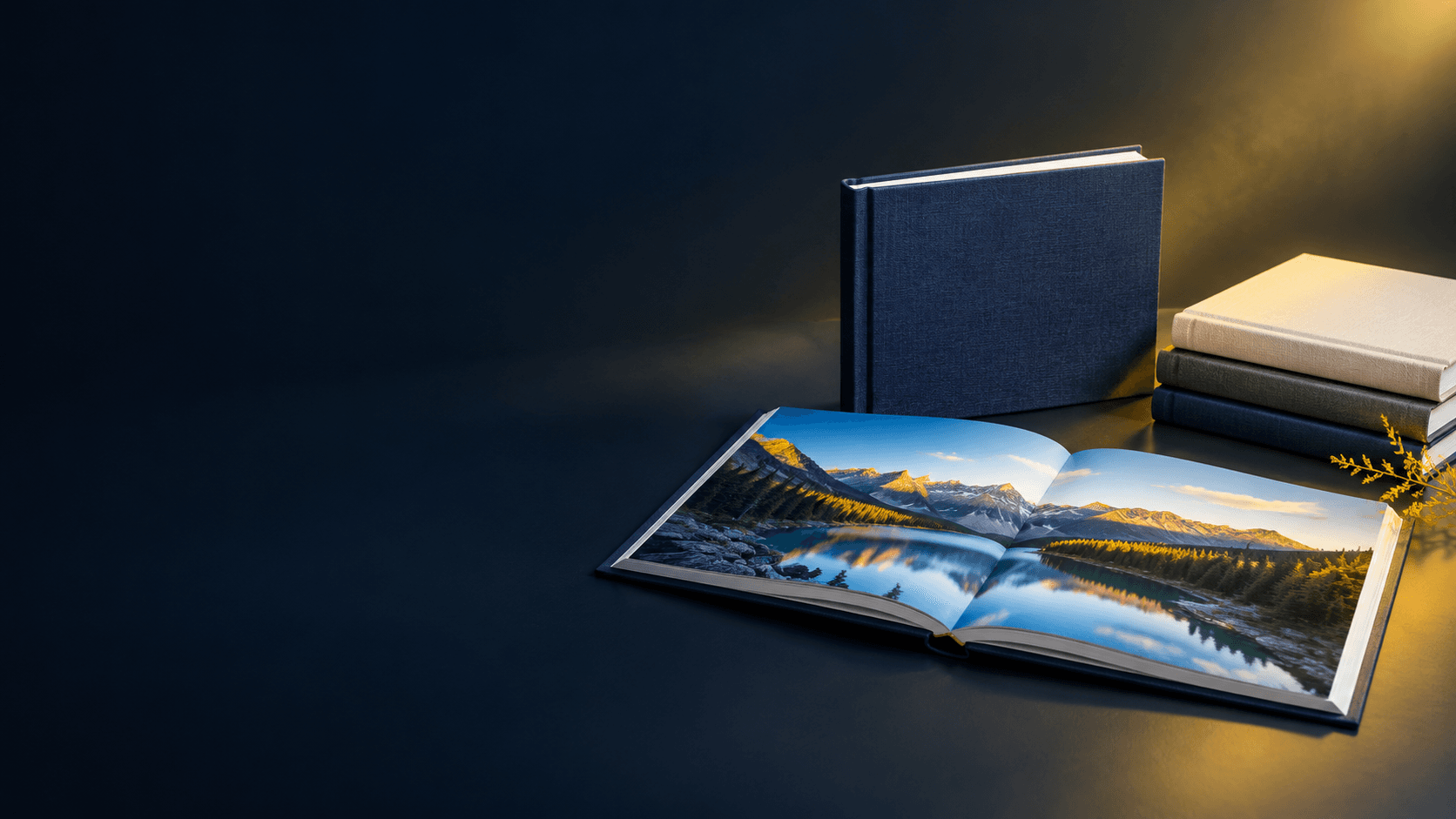 Open premium photo book and closed copies arranged in a studio