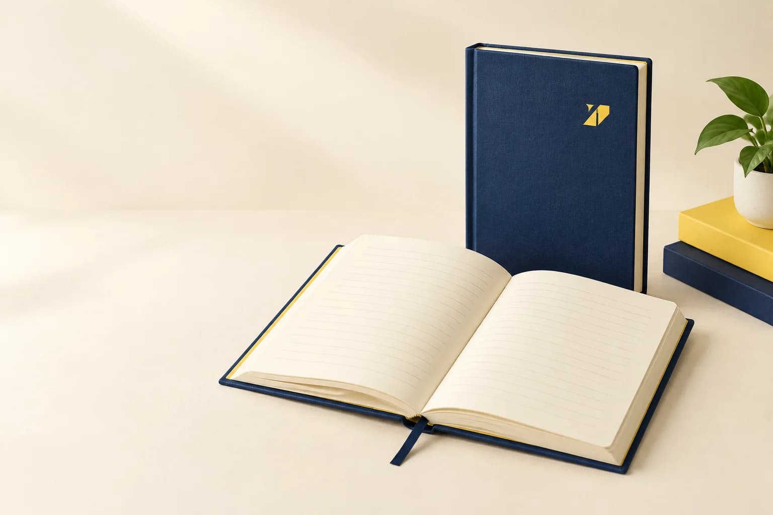 Illustrative navy hardcover notebooks with an open ruled page block and ribbon marker